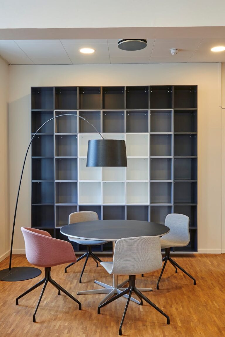 Bright and stylish office space with contemporary furniture and open shelving.